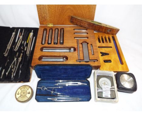 A good mixed lot to include two drawing sets, boxed, a J.Rathbone & Sons wooden and brass spirit level, a fountain pen set, a