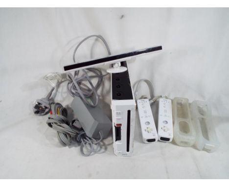 Nintendo WII - A Nintendo WII computer console with 2 numchucks, power cable and accessories