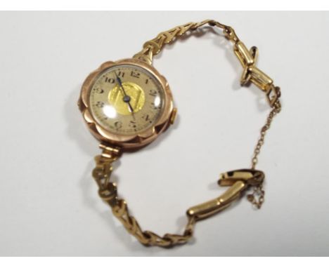 A lady's yellow metal wristwatch stamped 9 ct and associated bracelet and safety chain, Arabic numerals on a gilded dial, app