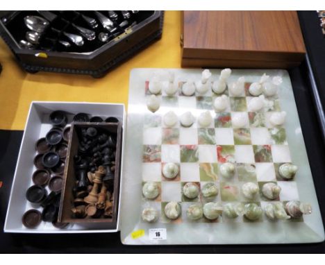 A marble complete chess set, a wooden set of chess pieces, King measuring 7.7 cm and a quantity of draughts counters (qty)