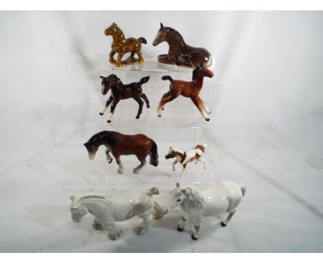 A collection of eight ceramic figurines depicting horses to include Beswick, Wade and other (qty)