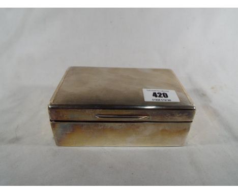 A George VI hallmarked silver cigarette box with engine turned decoration to the lid, London assay 1941, 5 cm x 14 cm x 9 cm 