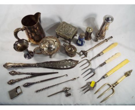 A good mixed lot of silver and plated ware comprising glove stretchers, button hook, cruets and other ornamental table ware