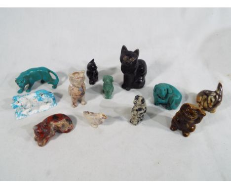 A collection of approximately twelve predominantly hard stone carved animals to include a tiger's eye Chinese cat, sandstone,