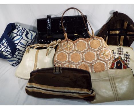 A collection of eight handbags to include Elizabeth Arden, a hand made cross stitch, leather bag, Jade of London and other