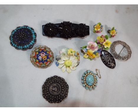 A good mixed lot of brooches to include a Whitby jet panel brooch with a floral decoration, a micro-mosaic, enamelled brooche