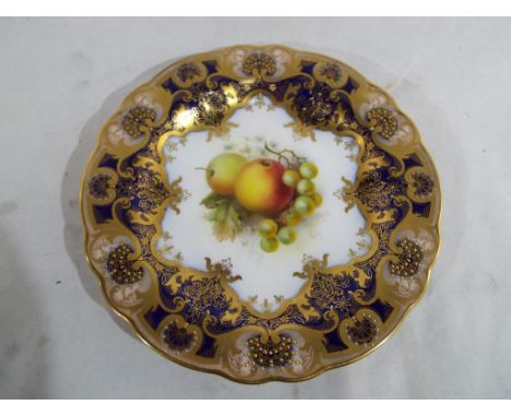 Royal Worcester - an early 20th century plate hand painted with depictions of fallen fruit within a border of cobalt blue wit