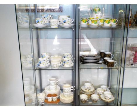 Three shelves containing a collection of ceramic tableware to include an approximately 26 piece Wellington tea service decora