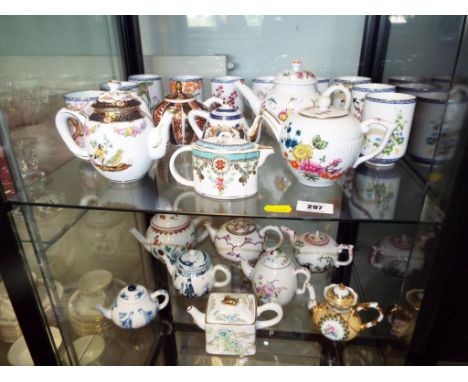 Two shelves containing a quantity of ceramic teapots to include Furstenberg, Art porcelain, Tournay, Kyoto and a collection o