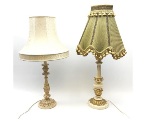 A cream and gilt finished table lamp, the turned base supporting a green pleated and tasselled shade, together with another s