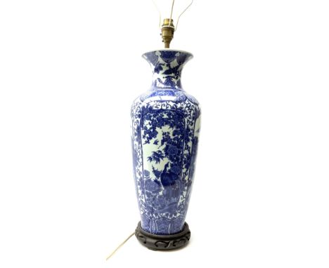 A Chinese blue and white table lamp, of slender baluster form decorated with alternate panels of landscapes and pheonix among