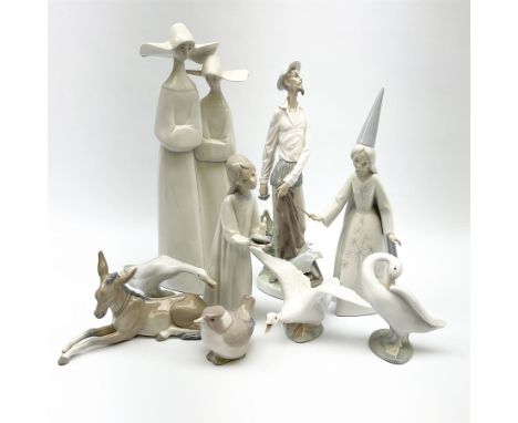 A group of nine Lladro figures, modelled in various forms including donkey, three geese, girl with chamber stick, etc. 