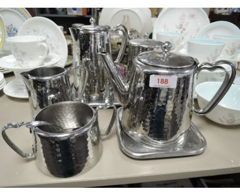 A Old Hall hammered finish stainless steel breakfast set including sugar basin, tray,jug and more.