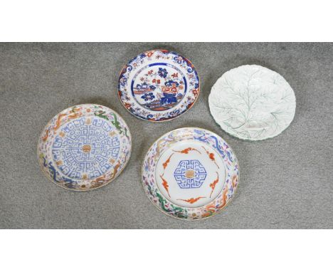 A collection of four ceramic and porcelain plates. Including two 18th century hand painted Chinese porcelain plates, one deco