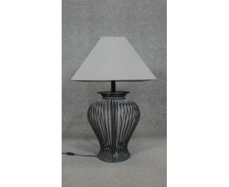 A vase design wrought iron table lamp with cream shade. H.79CM 