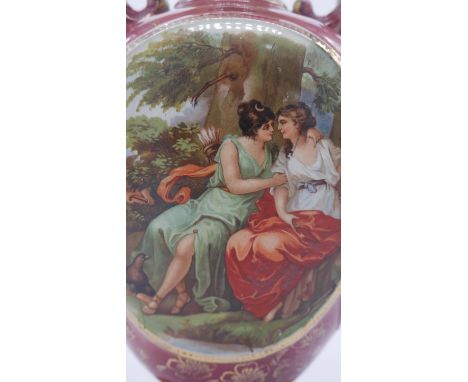 Two Royal Vienna ceramic twin handled urns with transfer design of a Classical scene of a pair of lovers and hand painted gil