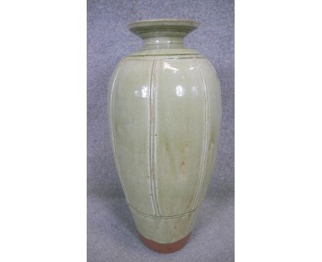 RICHARD BATTERHAM (1936-2021)- A tall terracotta bottle vase covered in green ash glaze and vertical linear design. H.64 x W.