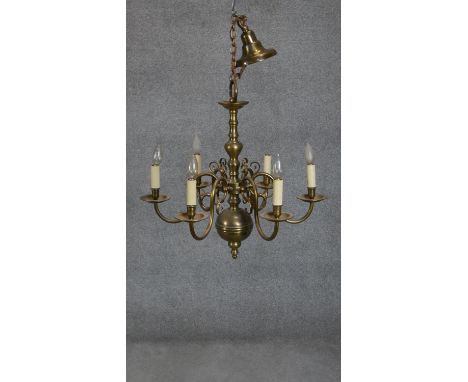 A Dutch style brass eight branch chandelier with scrolling design. H.66 D.70 