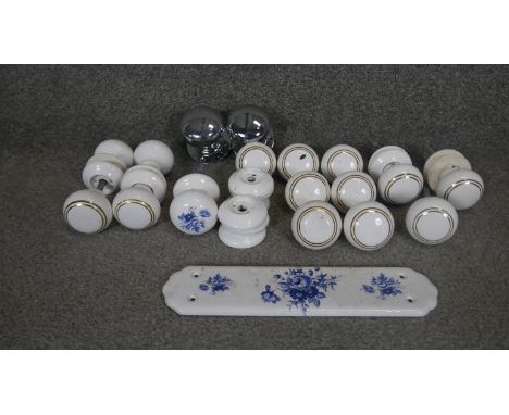 A collection of vintage and antique ceramic doorknobs and door plates. Some decorated with a blue floral design. 