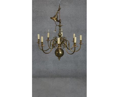 A Dutch style brass eight branch chandelier with scrolling design. H.70 D.90cm 