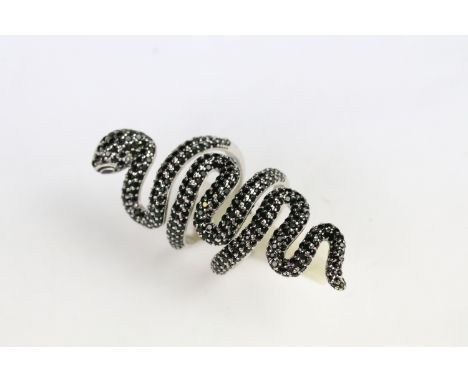 Silver and black stone snake ring. The ring in the form of a coiled serpent set throughout with round cut faceted black stone