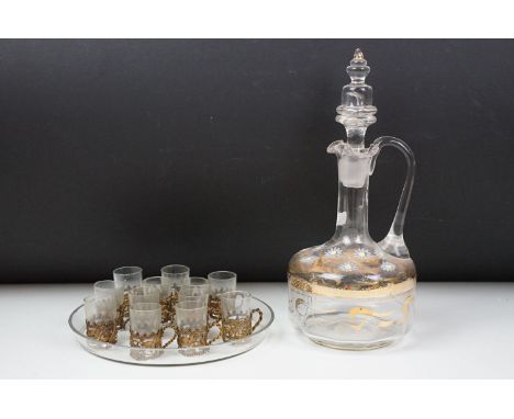 Late 19th / early 20th century communion set of 12 glasses with brass holders, with circular tray, plus a floral glass decant