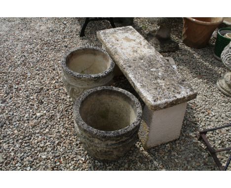 Stone garden bench raised on two supports (approx 96cm W x 45cm H), together with a pair of reconstituted stone planters with