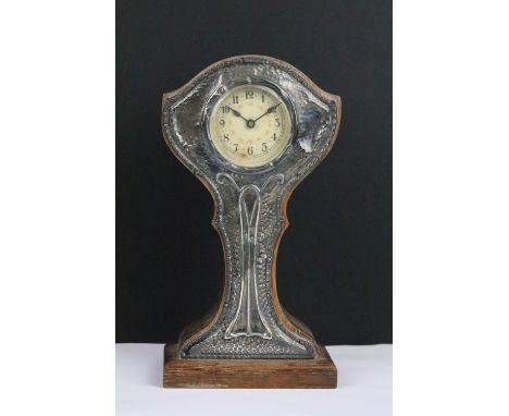 Early 20th Century oak mantle clock having a hammered Art Nouveau silver front and oak body. Hallmarked Birmingham 1912. 