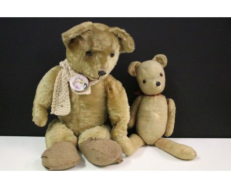 Two vintage teddy bears to include a felt bear with red neck tie and a larger example with joined limbs. 