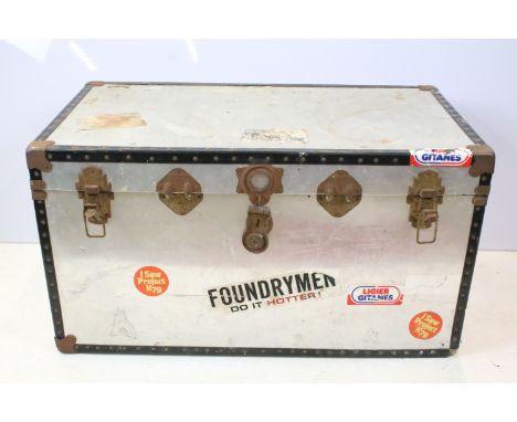 Vintage metal travel trunk with souvenir stickers to the sides and lids and metal locks with black banding to edges. 