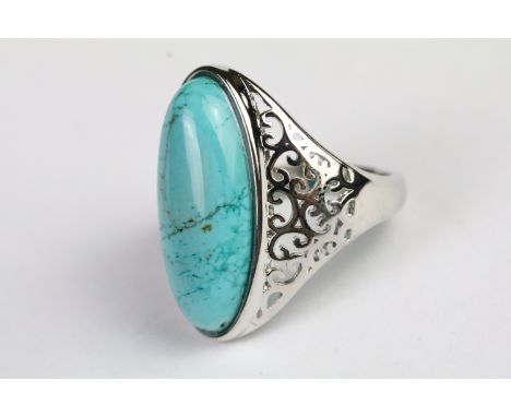 Silver and turquoise dress ring being set with an oval cabochon to centre with pierced shoulders. Marked 925. Size S.5. 