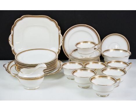 Aynsley tea service having gilt rims with greek key detailing to include seven tea cups, ten saucers, nine side plates, two s