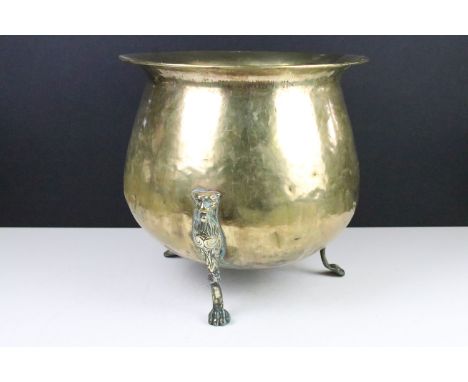 Victorian brass planter raised on three cast lion supports, approx 31cm tall 