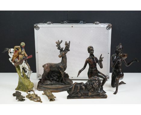 Collection of cast iron items to include a stag door stop, lion door knocker, two African figures, lion door stop all in flig