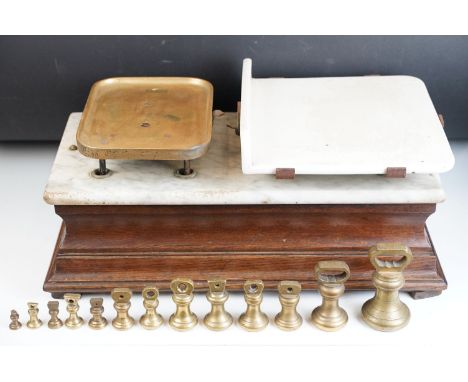 Victorian butcher shop grocer scales with set of brass weights. Carved Mahogany wood base with marble slab. scale platform in