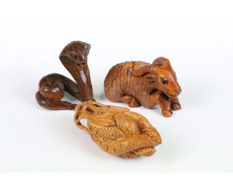 Two Chinese wooden netsuke in the form of a cobra snake and a ram together with a Chinese wooden carving of a fruit 