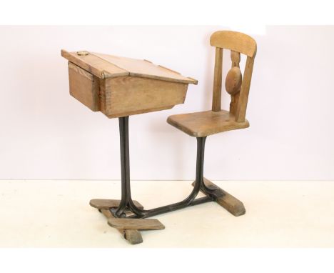 19th Century Victorian pitch pine school desk having a sloped desk top with brass fitted inkwell, opening to reveal storage w