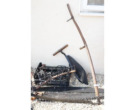 Collection of assorted tools and metal wares to include large hand saws, sithe, saddle rack etc.