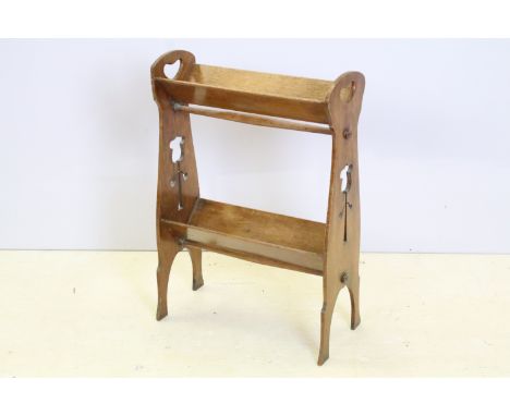 Early 20th Century Arts and Crafts carved oak book shelf having two books troughs with pierced end supports. Measures 65 x 45
