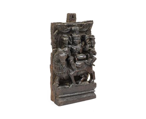 An Indian Carved Wood Architectural Section, 19th century, worked in high relief with Shiva and Parvati riding the sacred bul