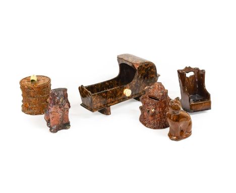 A Slipware Pottery Model of a Cradle, late 19th century, with arched canopy and on rocking base29cm longA Similar Treacle Gla