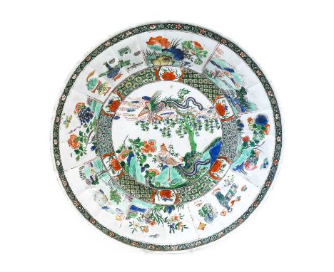 A Chinese Porcelain Dish, Kangxi, of circular form, painted in famille verte enamels with phoenix amongst foliage and rockwor