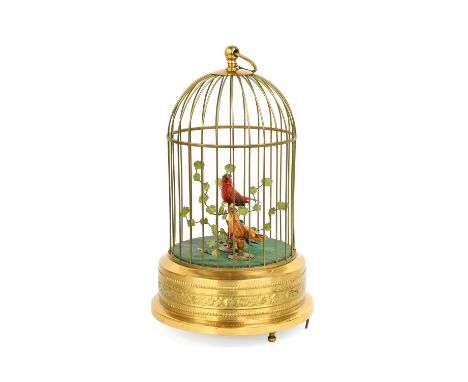 A Singing Bird Automata, 20th century, with two birds and a tree in a brass domed cage, on a drum base with clockwork movemen