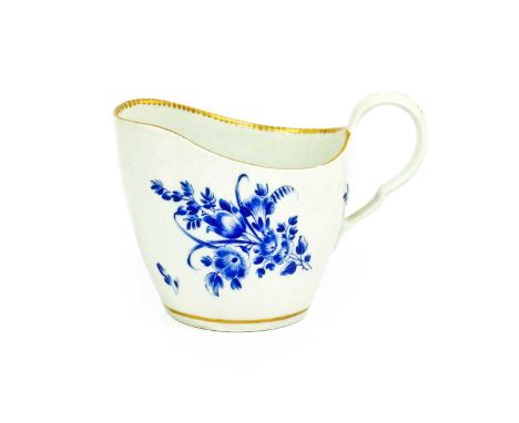 A Worcester Porcelain Cream Jug, circa 1770, of ovoid form and with scrolling handle, decorated with gilt dentil rim and dry 