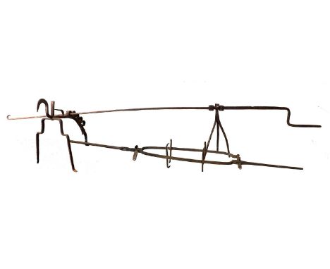 A Continental Wrought Andiron and Spit, 17th century, of scroll form and with five tiered spit rests210cm longA Similar Spit1