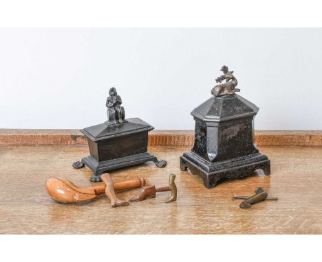 A Clay Pipe in Treen Case, 19th century15.5cm longFour Novelty Pipe Tampers, each formed as bootslargest 7cmTwo Cast Iron Tob