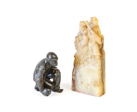 A Chinese Soapstone Hand Seal, late Qing Dynasty, carved with figures on a rectangular base inscribed with calligraphy, the m