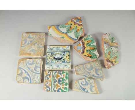 NINE 17TH CENTURY GLAZED POTTERY POLYCHROME TILE FRAGMENTS, various sizes, (9).