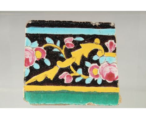AN 18TH-19TH CENTURY PERSIAN QAJAR GLAZED POTTERY TILE, 9.5cm x 11cm.