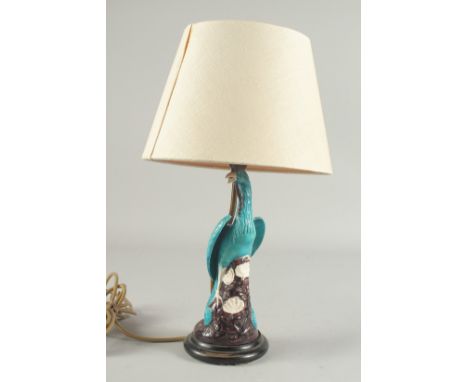 A CHINESE TURQUOISE GLAZE PORCELAIN PEACOCK PHOENIX, converted to a lamp base and mounted to a circular wooden stand, figure 